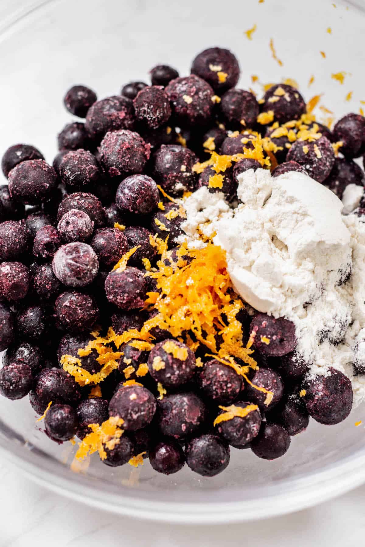 blueberries, flour and orange zest in a bowl.