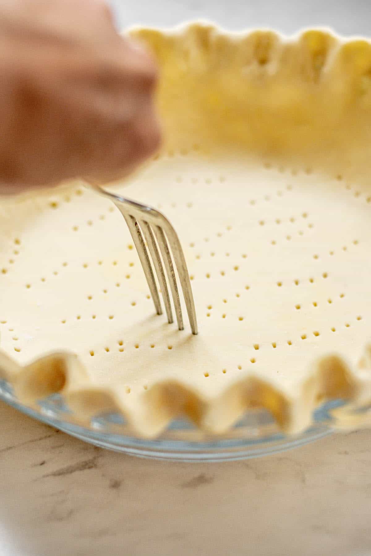 fork pricking pastry.