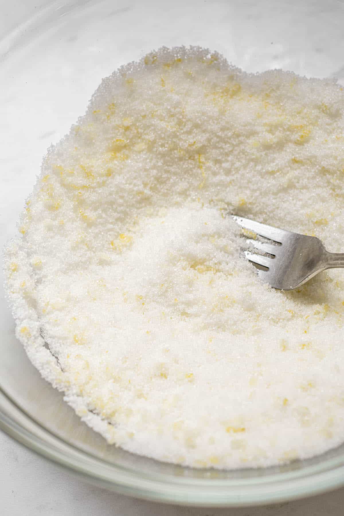 lemon zest in sugar with a fork.