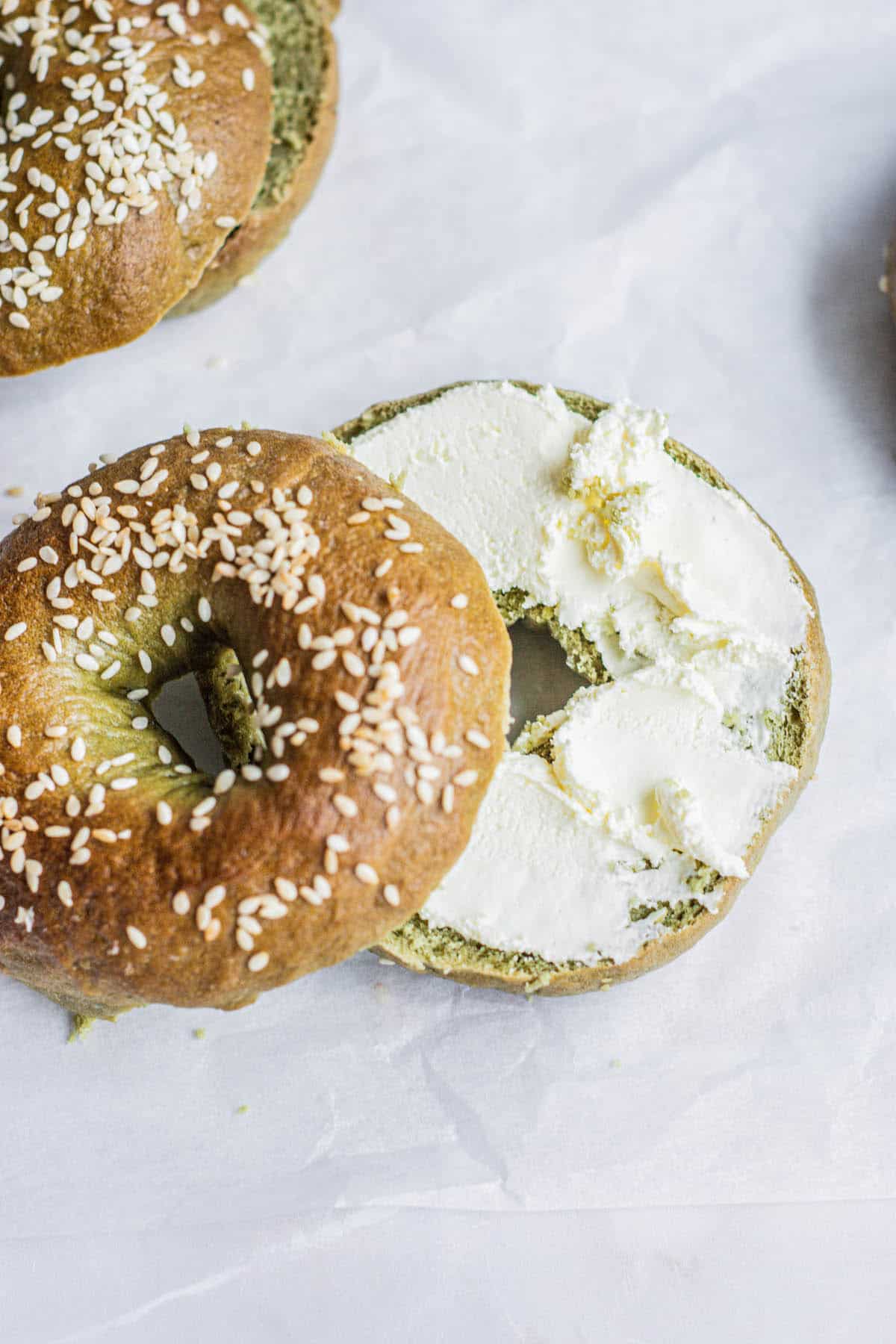 halved bagel with cream cheese.