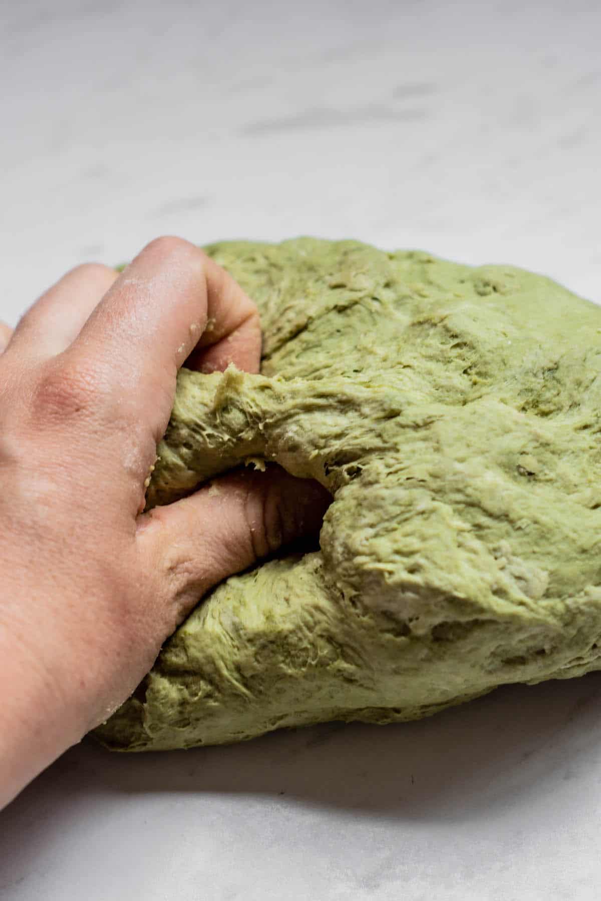 hand kneading dough.