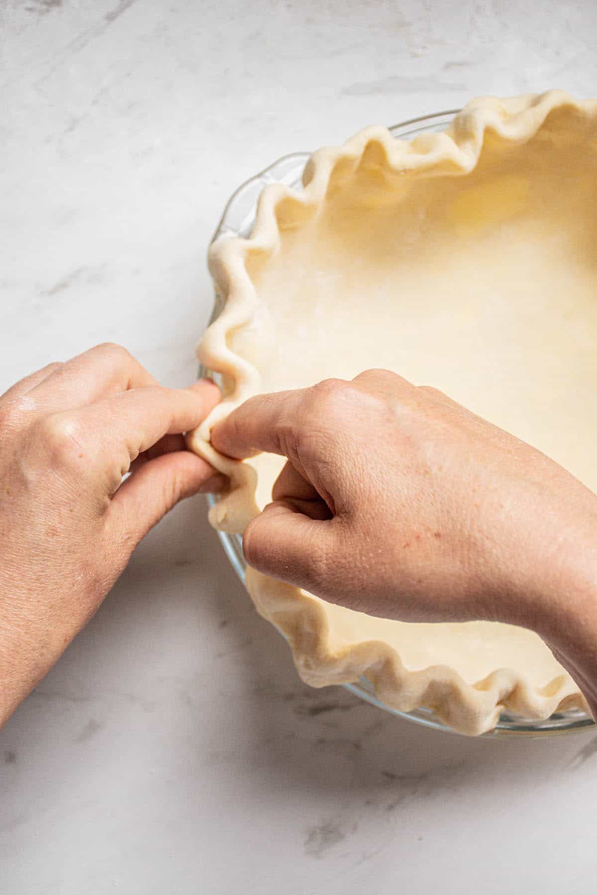 hand folding pie dough.