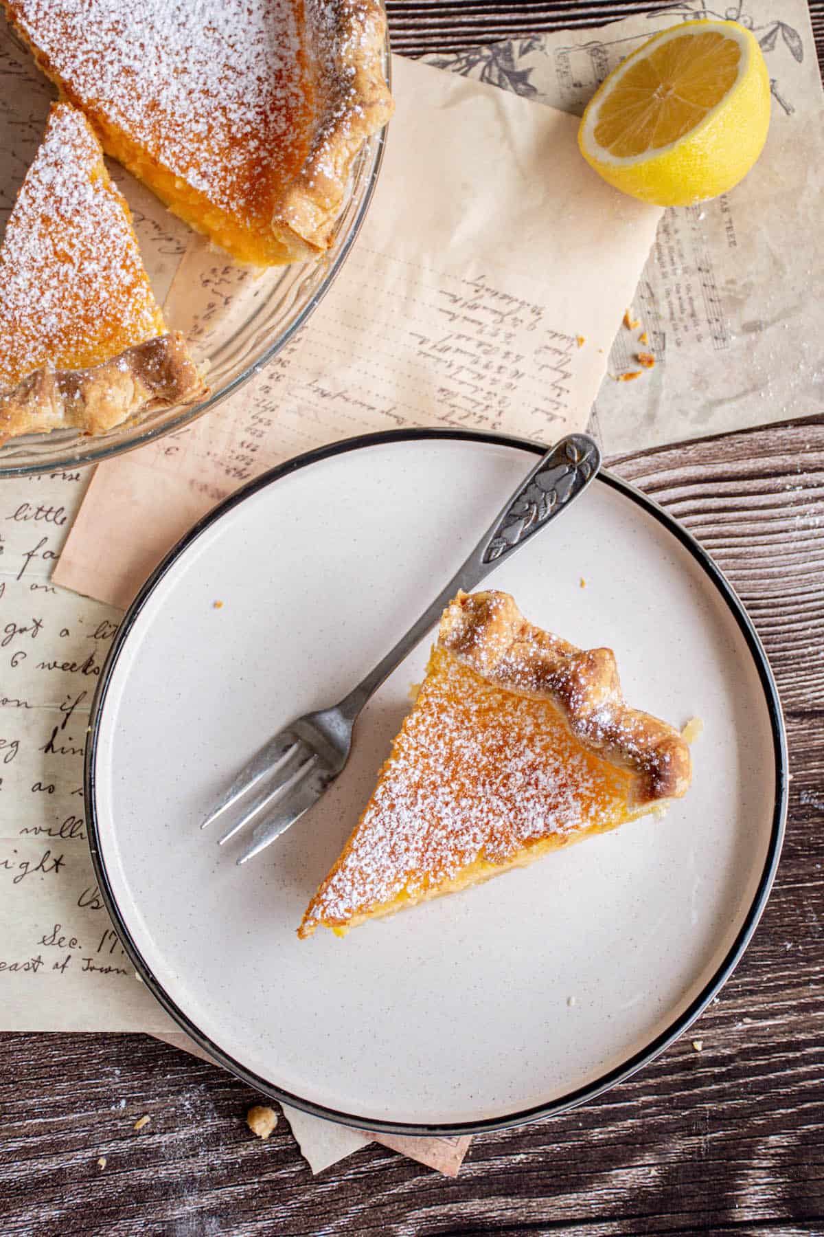 Bird's eye view of a lemon pie on wooden table.