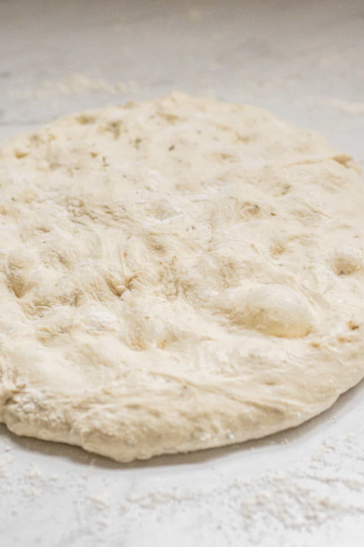 flattened dough on work surface.