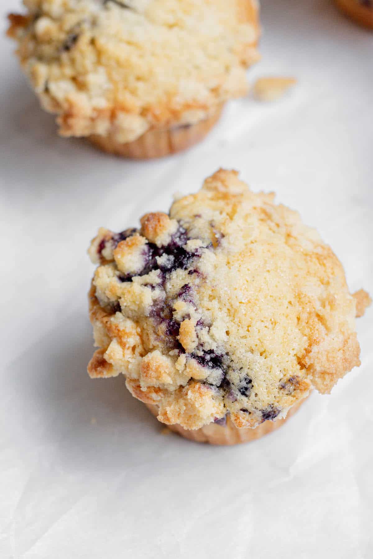 close up of blueberry muffin with streusel topping.