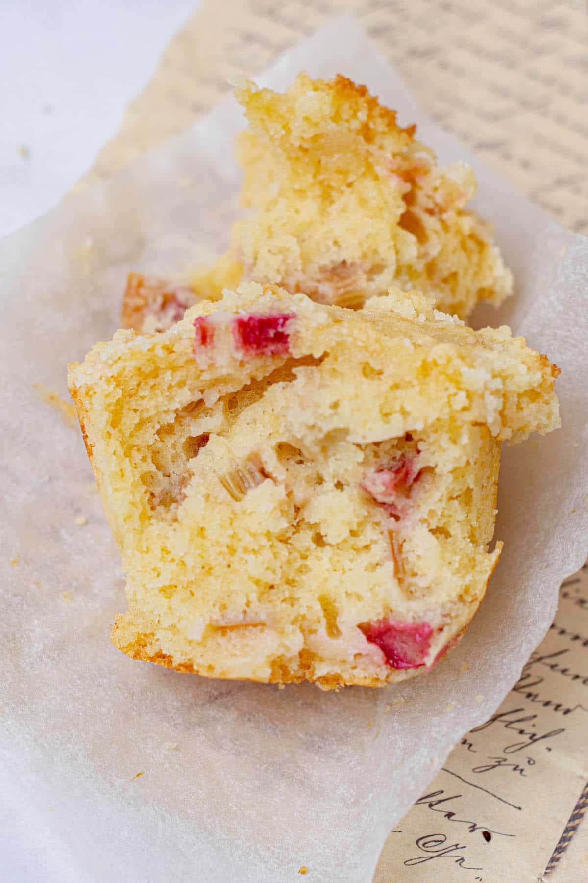 halved muffin with lots of rhubarb pieces showing.