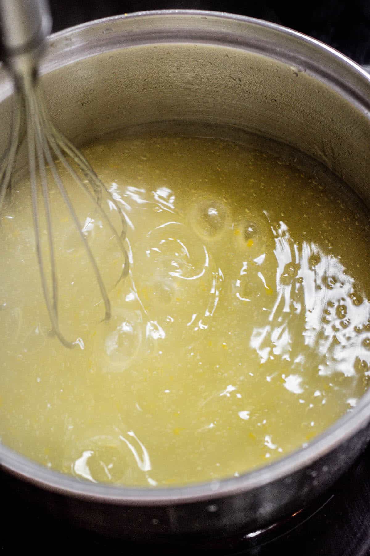 whisking curd with bubbles.