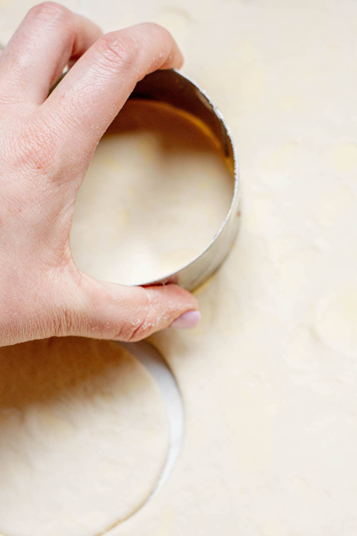 hand cutting dough circles.