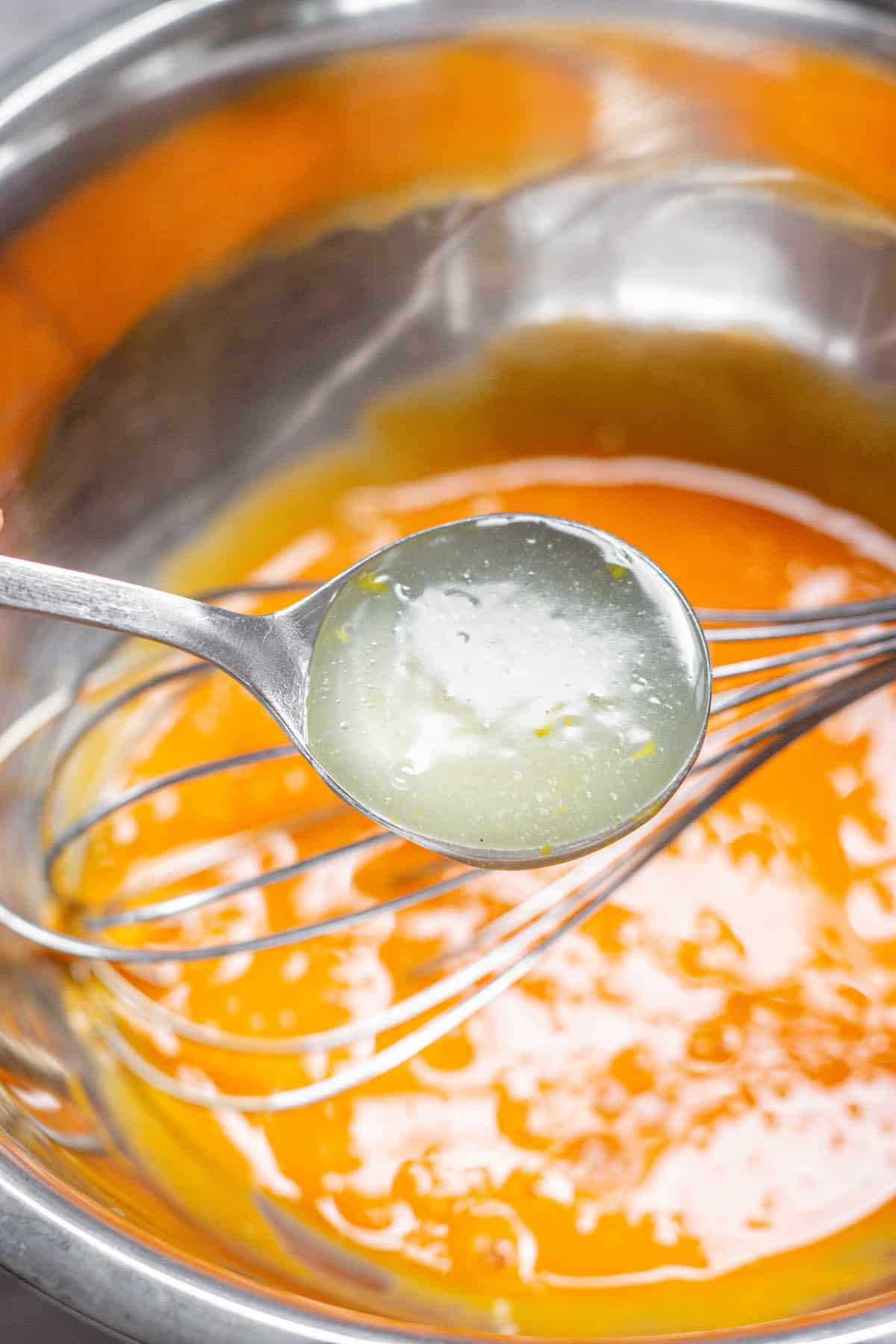 spoon ful of hot curd added to egg yolks.