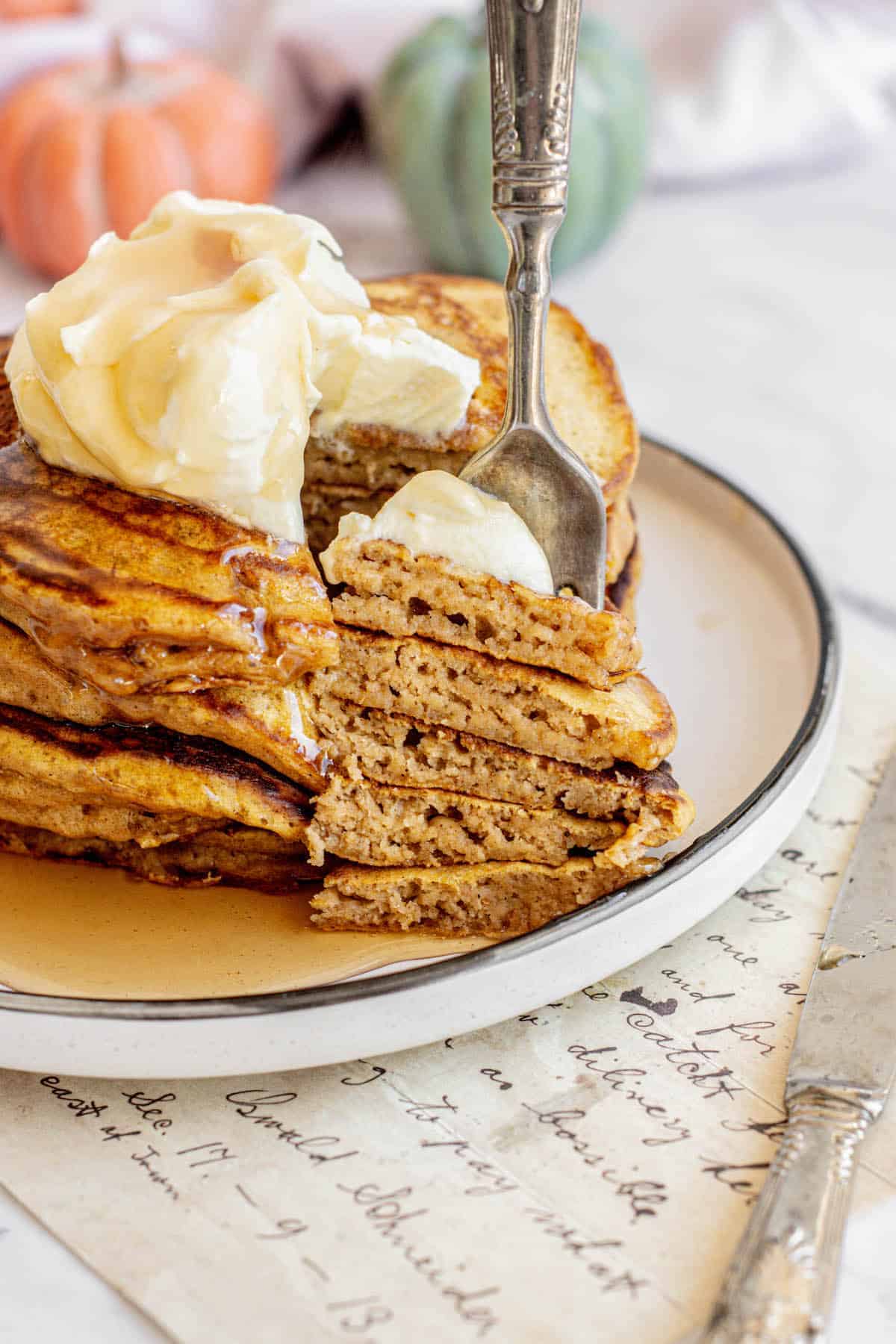 a stack and forkful of pumpkin sourdough pancakes