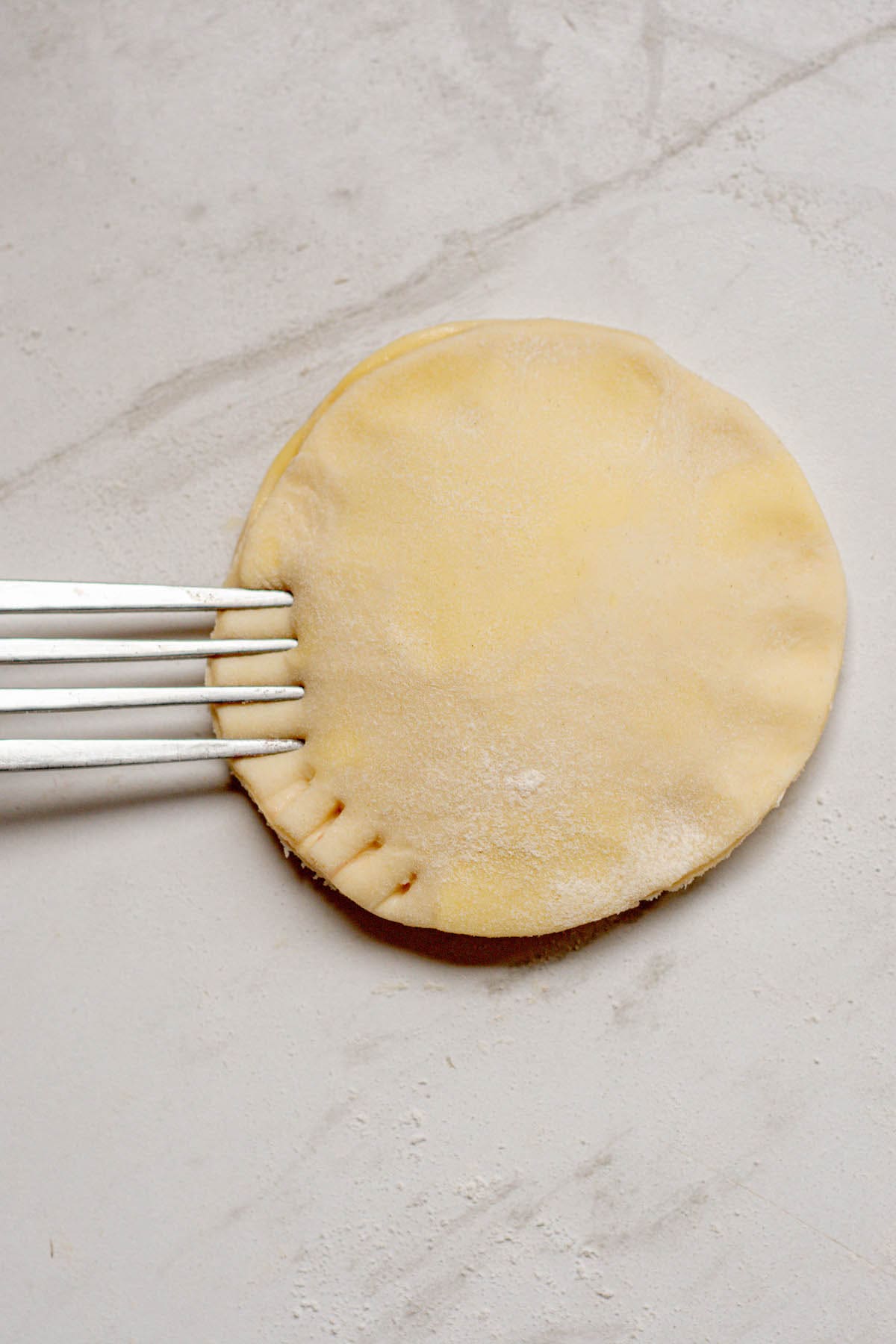 fork pressing down on dough.