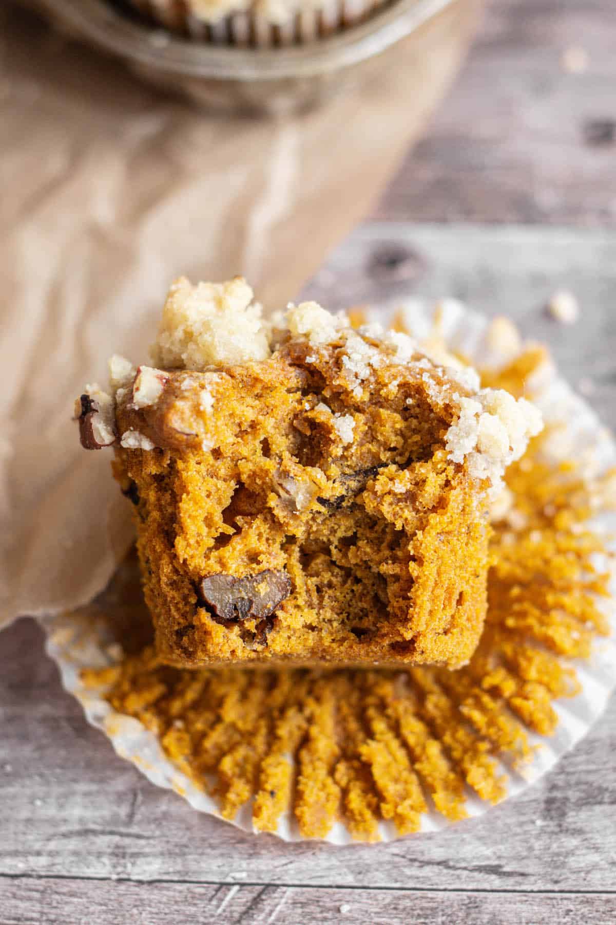 bitten pumpkin pecan muffin with streusel.