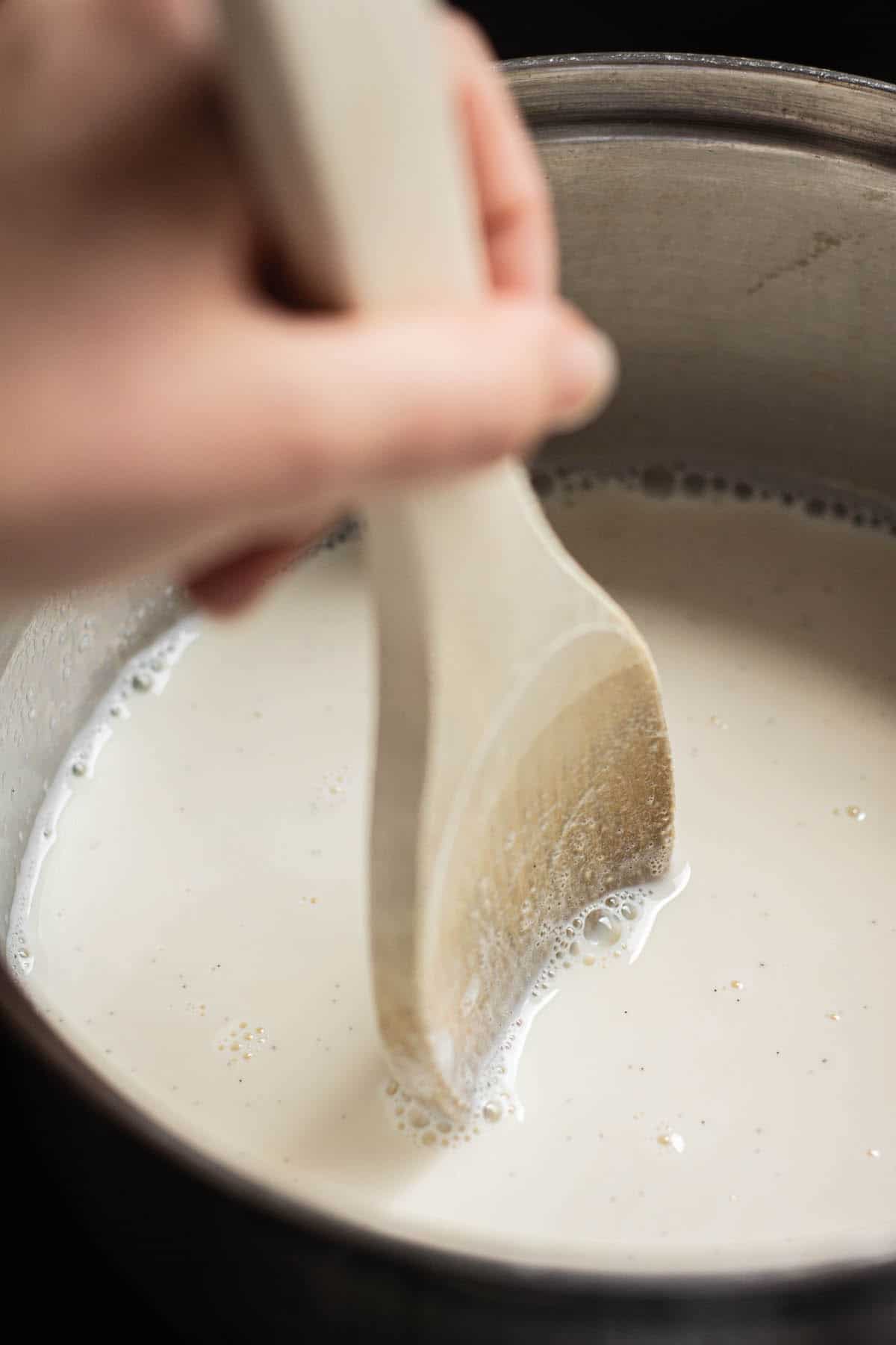 spoon stirring hot milk.