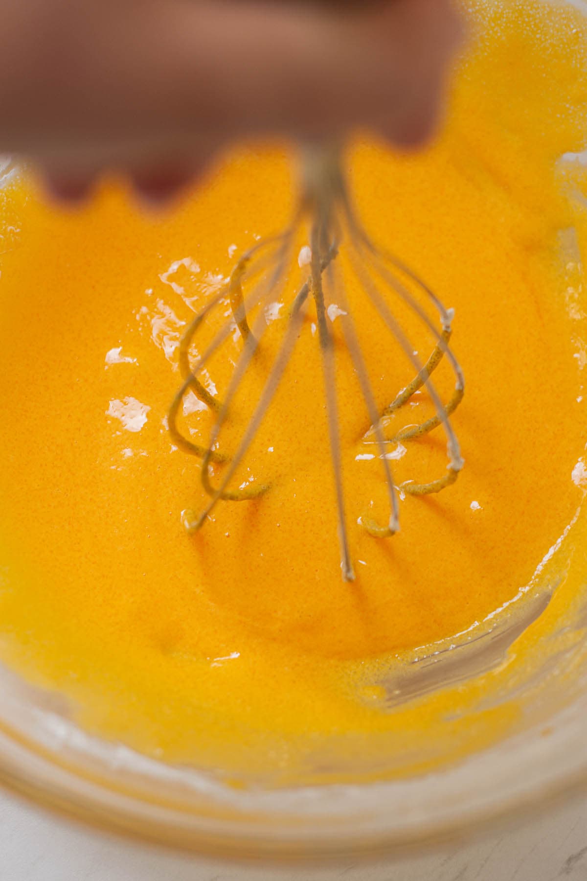 whipped egg yolks in a glass bowl.