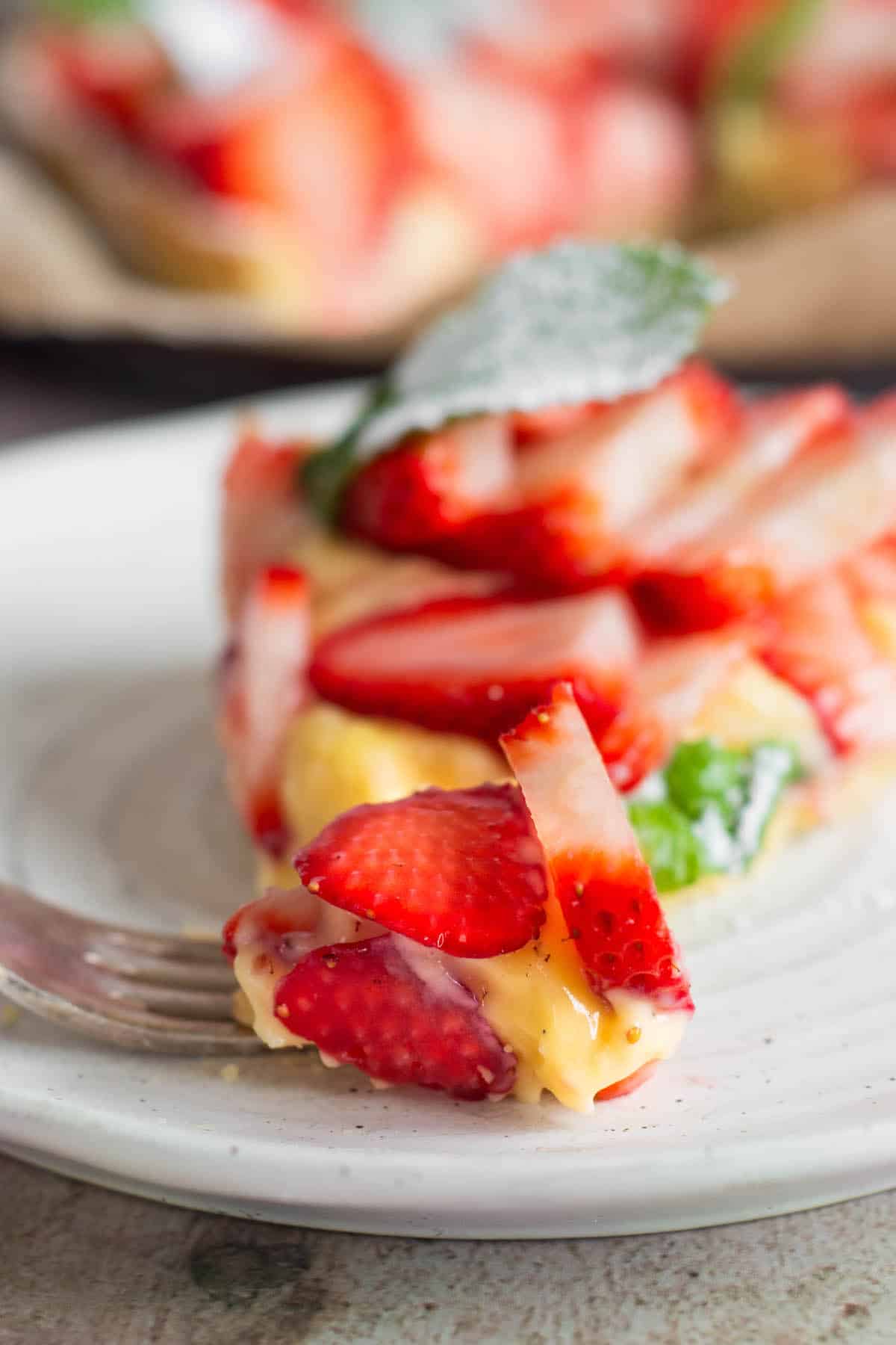 close up of slice of strawberry custard tart.