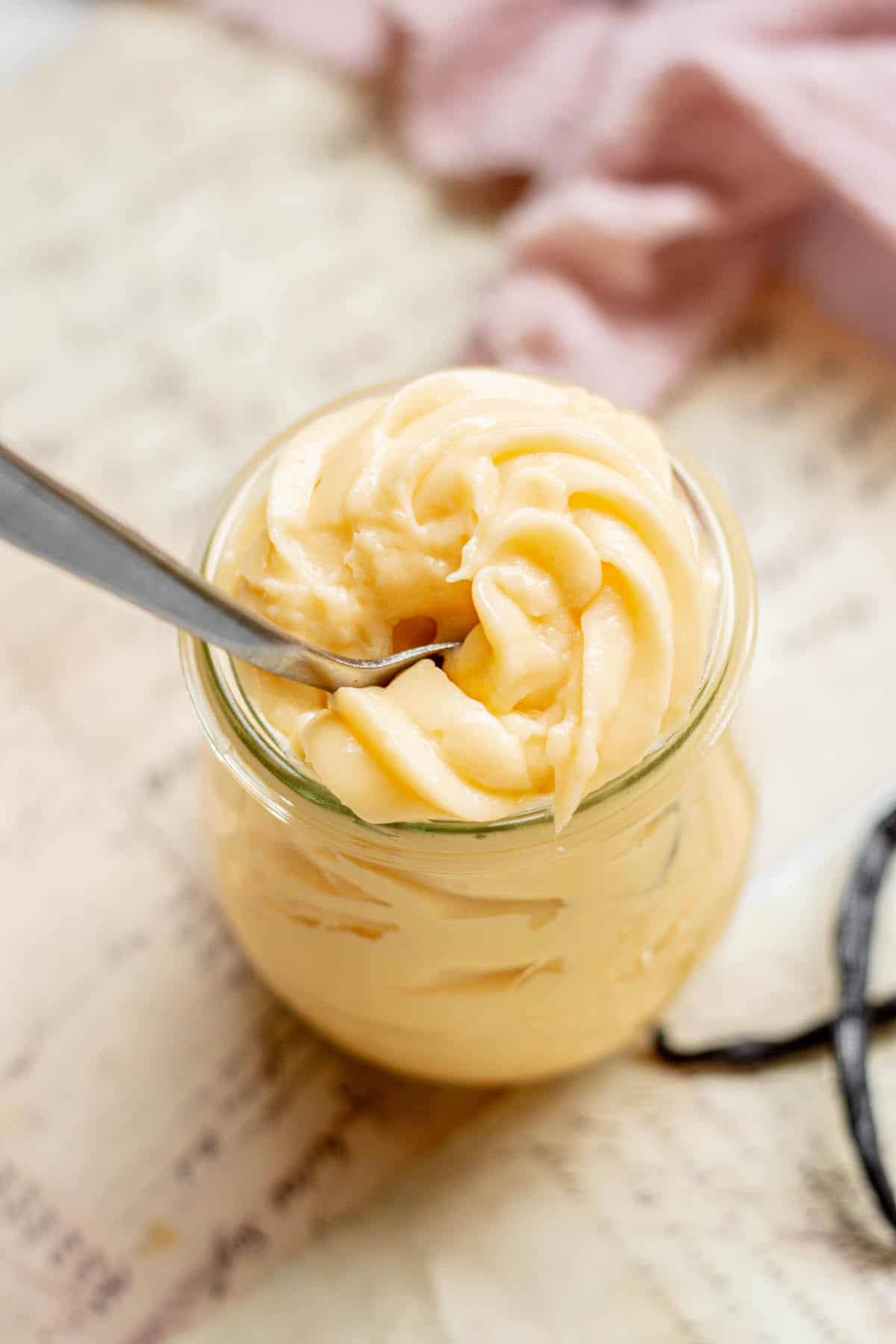 a spoon in a jar of creme pattisiere.