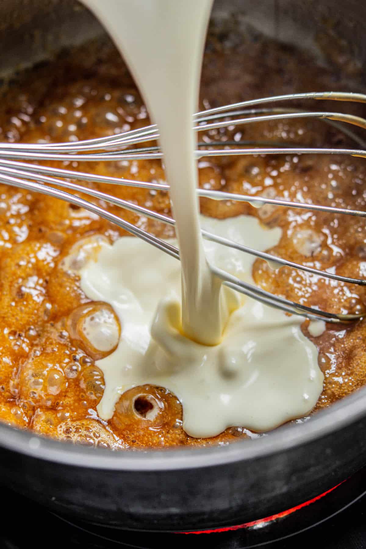 cream being poured into caramel.