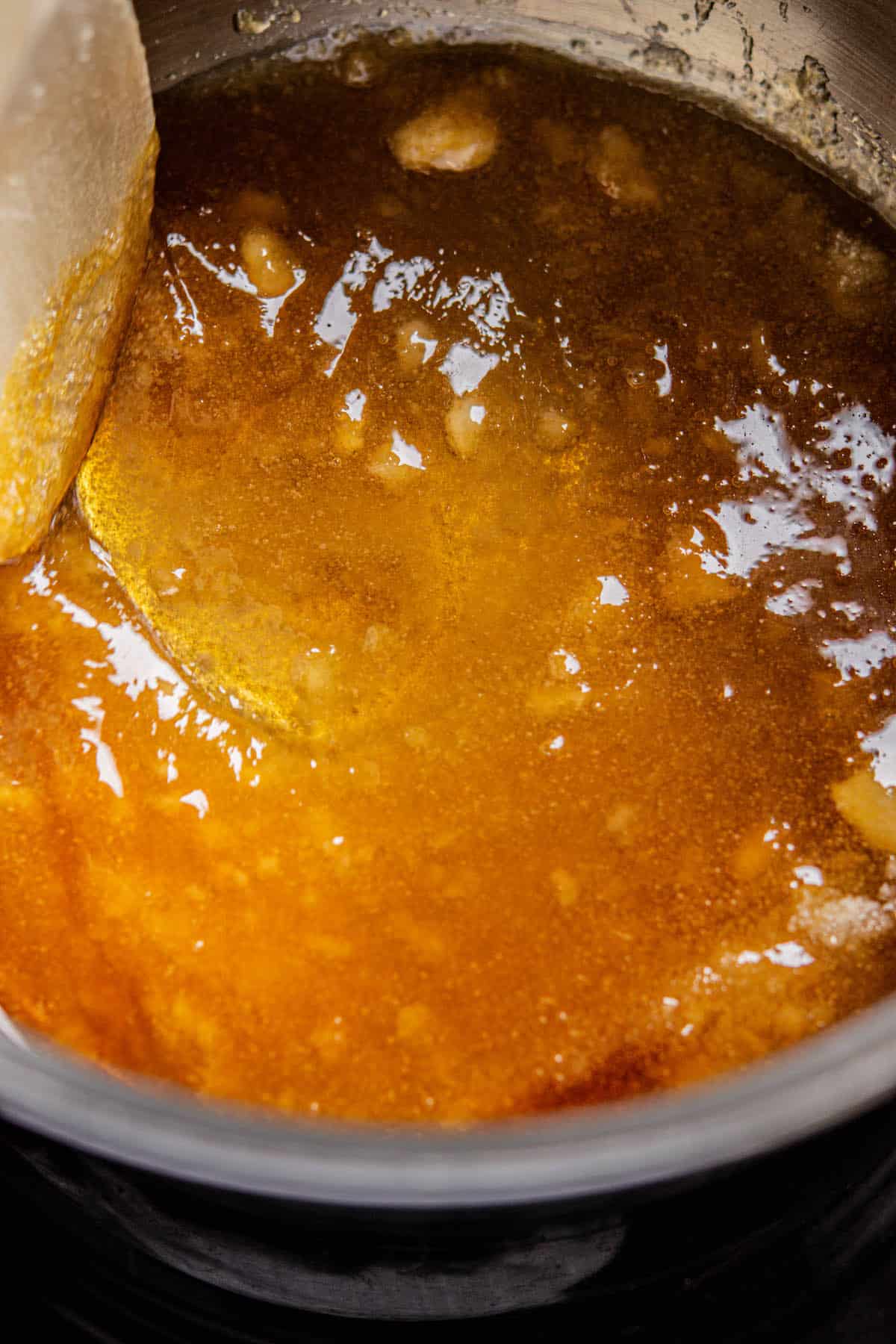 amber brown melted sugar in a pot.