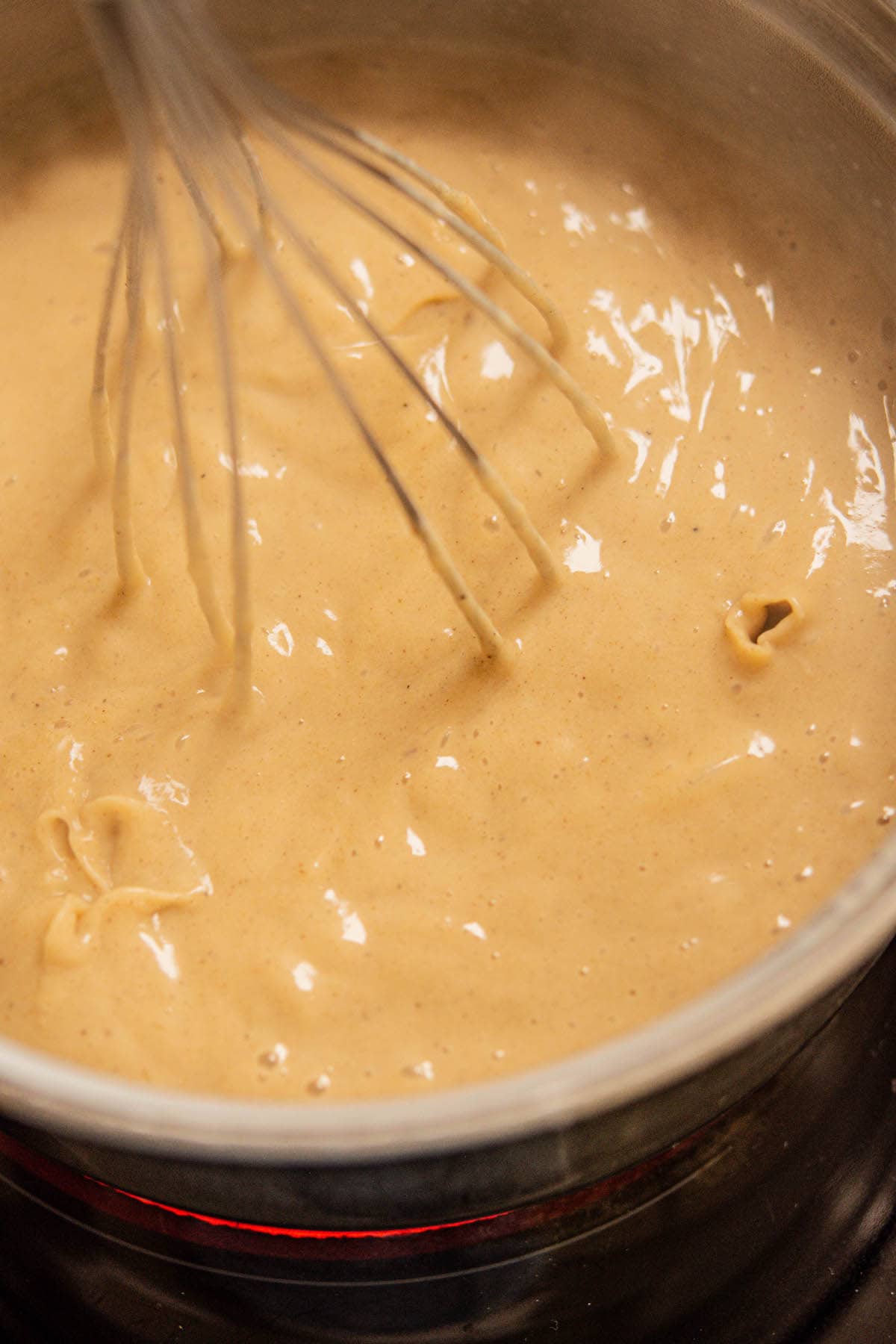 gingerbread custard bubbling in saucepan.