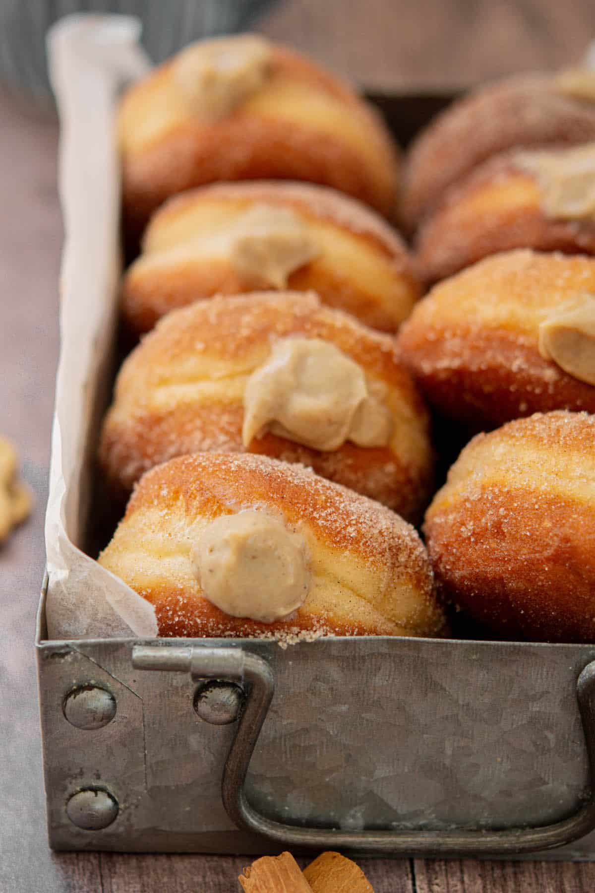 side view of gingerbread custard doughnuts.