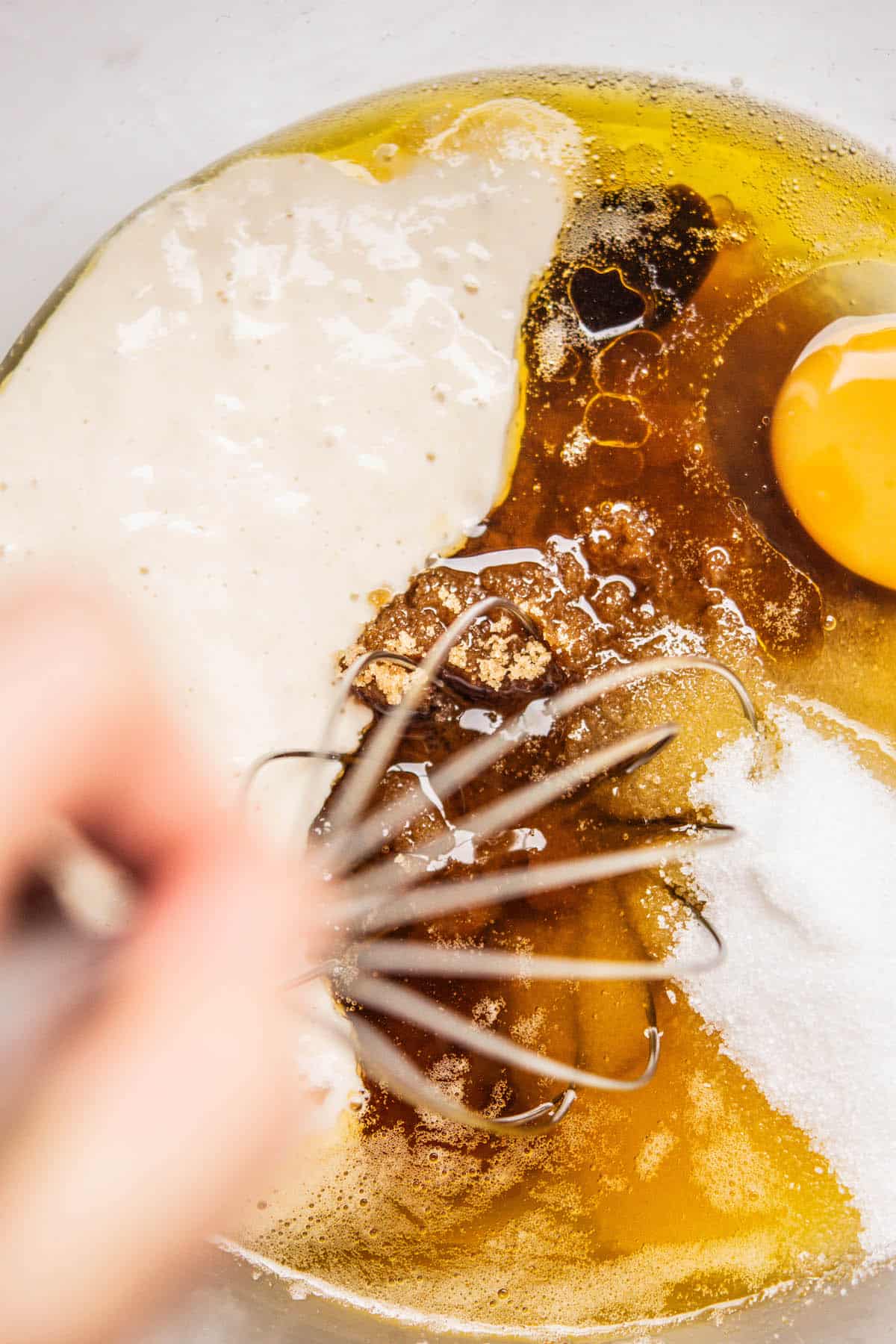 egg, starter, sugar and butter being whisked.