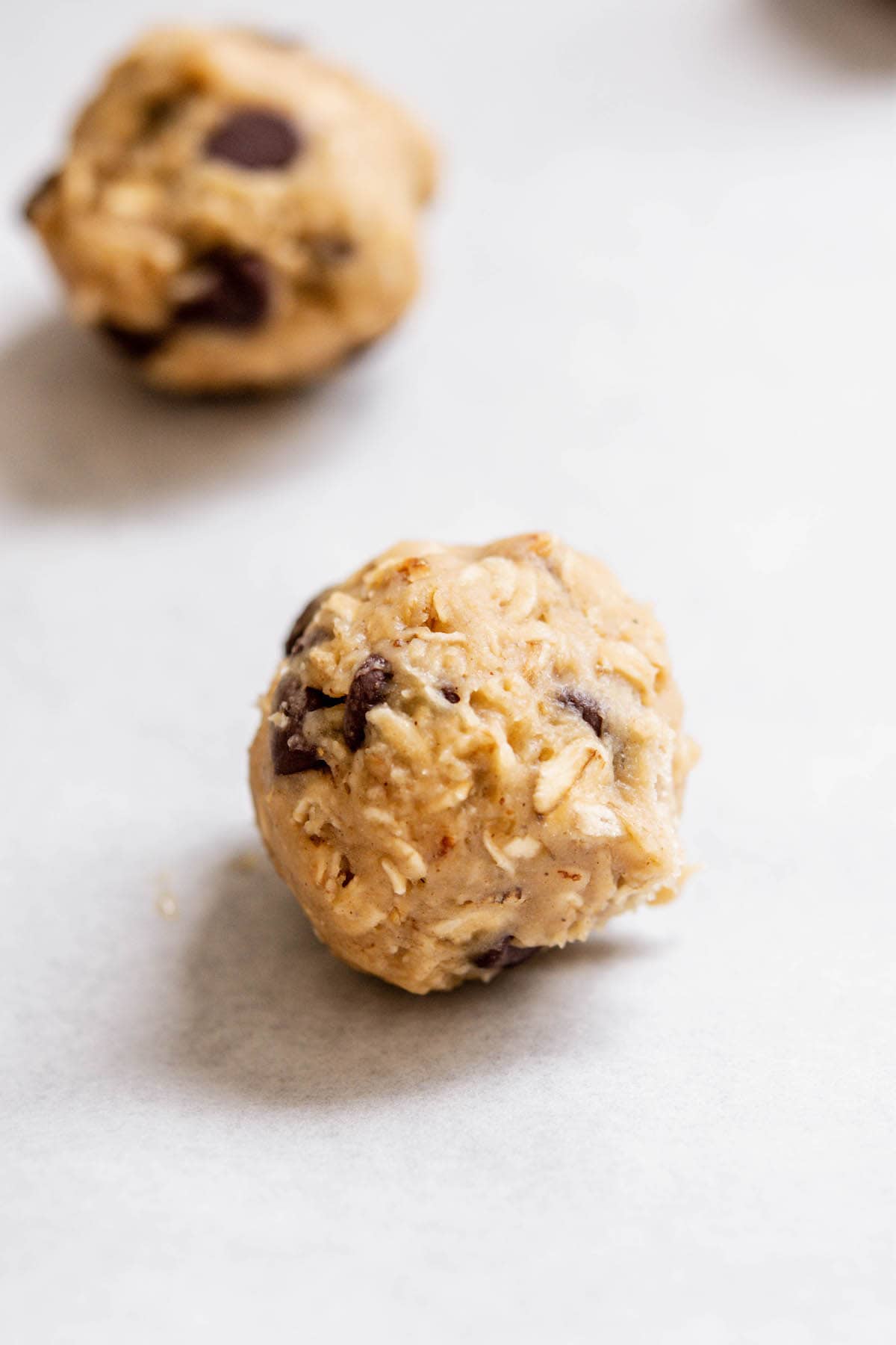cookie dough ball on parchment paper.