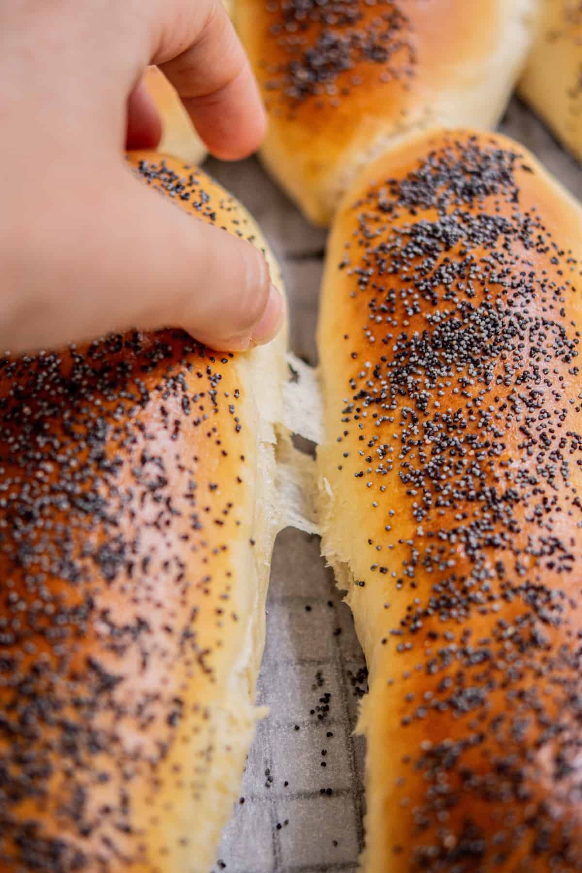 hand pulling apart hot dog buns.