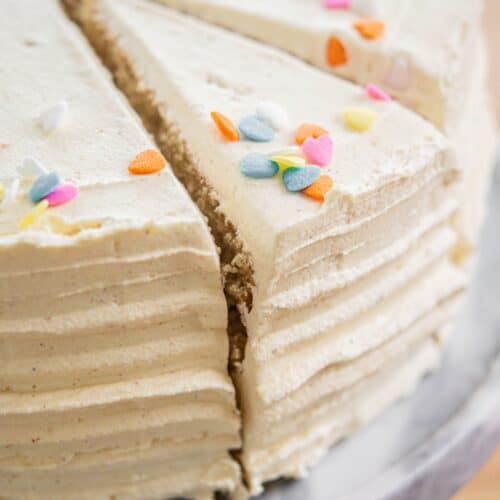 slice of vanilla cake being taken from cake.